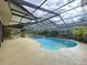A screened-in pool with a hot tub and plenty of patio space for outdoor entertaining at 232 Pinecrest Dr, Palm Harbor, FL 34683
