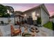 Charming backyard with a cozy fire pit, pergola-covered seating, and white gravel against house elevation at 260 Sw Lincoln N Cir, St Petersburg, FL 33703