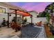 Relaxing backyard boasts a shaded pergola, fire pit, and seating, ideal for outdoor entertaining at 260 Sw Lincoln N Cir, St Petersburg, FL 33703