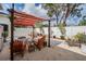Inviting backyard features a pergola, seating area, fire pit, and tasteful landscaping against a white fence at 260 Sw Lincoln N Cir, St Petersburg, FL 33703
