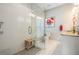 Bathroom with large glass shower, granite vanity and countertop, and a window with white shutters at 260 Sw Lincoln N Cir, St Petersburg, FL 33703