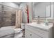 Bathroom featuring a tub and shower combination, wood-style tile, and modern fixtures at 260 Sw Lincoln N Cir, St Petersburg, FL 33703