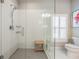 Bathroom with large glass shower and bench, modern shower head, and a window with white shutters at 260 Sw Lincoln N Cir, St Petersburg, FL 33703