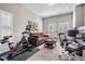 Bonus room being used as an office and gym with home gym equipment, couch, and work space at 260 Sw Lincoln N Cir, St Petersburg, FL 33703