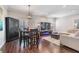Open-concept dining area with hardwood floors, stylish furnishings and nearby entertainment area at 260 Sw Lincoln N Cir, St Petersburg, FL 33703