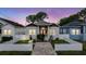 Charming home featuring a brick walkway, white picket fence, and delightful curb appeal at 260 Sw Lincoln N Cir, St Petersburg, FL 33703