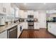 White kitchen with granite countertops, stainless steel appliances, hardwood floors and plenty of cabinet space at 260 Sw Lincoln N Cir, St Petersburg, FL 33703