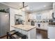 Well-lit kitchen with stainless steel appliances, granite countertops, a center island and hardwood floors at 260 Sw Lincoln N Cir, St Petersburg, FL 33703