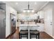 Bright kitchen featuring white cabinetry, granite counters, and stainless steel appliances at 260 Sw Lincoln N Cir, St Petersburg, FL 33703
