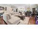 Bright living room featuring a cozy sectional sofa, hardwood floors and ample natural light at 260 Sw Lincoln N Cir, St Petersburg, FL 33703