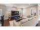 Inviting living room features a comfortable sectional sofa and entertainment center with accent lighting at 260 Sw Lincoln N Cir, St Petersburg, FL 33703