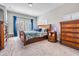 Main bedroom with beautiful wooden furniture, cozy carpet, and bright windows with stylish blue curtains at 260 Sw Lincoln N Cir, St Petersburg, FL 33703