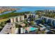 Aerial view highlighting the pool, waterfront location, and building layouts in this desirable community at 2614 Cove Cay Dr # 409, Clearwater, FL 33760