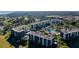 An aerial view of well-maintained buildings, a refreshing pool area, and lush green golf courses in this community at 2614 Cove Cay Dr # 409, Clearwater, FL 33760