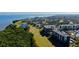 Extensive aerial view of the property's layout, with golf courses, buildings, and a scenic waterfront backdrop at 2614 Cove Cay Dr # 409, Clearwater, FL 33760