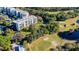 Comprehensive aerial shot displaying golf course, buildings, and natural surroundings, showcasing community amenities at 2614 Cove Cay Dr # 409, Clearwater, FL 33760