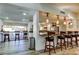 Stylish bar area with wood stools, pendant lighting, and a view of the outdoors at 2614 Cove Cay Dr # 409, Clearwater, FL 33760