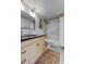 Lovely bathroom features a light wood vanity with black counter and updated tub with shower at 2614 Cove Cay Dr # 409, Clearwater, FL 33760