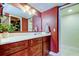Bathroom with an expansive vanity with white marble countertop and dark wood cabinets at 2614 Cove Cay Dr # 409, Clearwater, FL 33760