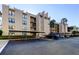 Condominium building featuring covered parking, balconies, and a well-maintained exterior at 2614 Cove Cay Dr # 409, Clearwater, FL 33760