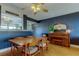 The dining room has a piano and dark accent wall with a ceiling fan at 2614 Cove Cay Dr # 409, Clearwater, FL 33760