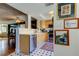 Well-lit kitchen with light wood cabinetry, stainless steel appliances and a view into the dining room at 2614 Cove Cay Dr # 409, Clearwater, FL 33760