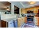 Bright kitchen featuring modern stainless steel appliances and light wood cabinets and white countertops at 2614 Cove Cay Dr # 409, Clearwater, FL 33760