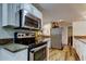 Modern kitchen featuring stainless steel appliances and granite countertops at 2614 Cove Cay Dr # 409, Clearwater, FL 33760