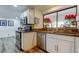 Well-lit kitchen with stainless steel appliances and a garden window, perfect for cooking and cleaning at 2614 Cove Cay Dr # 409, Clearwater, FL 33760