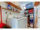 Laundry room with washer, dryer, shelving, and storage solutions at 2614 Cove Cay Dr # 409, Clearwater, FL 33760