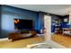 Cozy living room with a television and shelving unit at 2614 Cove Cay Dr # 409, Clearwater, FL 33760