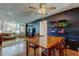 Spacious living room with a ceiling fan, dark accent wall and views out large windows at 2614 Cove Cay Dr # 409, Clearwater, FL 33760