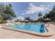 Outdoor pool with many chairs and umbrellas on a bright and sunny day at 2614 Cove Cay Dr # 409, Clearwater, FL 33760