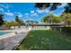 Expansive backyard featuring a lush lawn, pool, and outdoor living space, ideal for recreation and relaxation at 2679 Haines Bayshore Rd, Clearwater, FL 33760