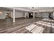 Large basement featuring wood-look flooring, recessed lighting, support beams, and wet bar for entertaining at 2679 Haines Bayshore Rd, Clearwater, FL 33760