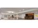 Spacious basement with wood-look flooring, fireplace, wet bar with wood accent wall and white trim throughout at 2679 Haines Bayshore Rd, Clearwater, FL 33760