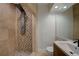 Modern bathroom featuring a shower with multiple shower heads and stylish earth-tone tile work at 2679 Haines Bayshore Rd, Clearwater, FL 33760