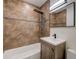 Bathroom with modern shower and vanity featuring earth-tone tiling at 2679 Haines Bayshore Rd, Clearwater, FL 33760