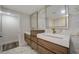Elegant bathroom with dual sinks, modern fixtures, and marble-style walls for a luxurious feel at 2679 Haines Bayshore Rd, Clearwater, FL 33760