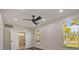 Bright bedroom with two windows and a modern ceiling fan at 2679 Haines Bayshore Rd, Clearwater, FL 33760