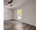 Bright bedroom featuring sleek, modern flooring and a ceiling fan at 2679 Haines Bayshore Rd, Clearwater, FL 33760