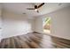 Bedroom with hardwood floors, ceiling fan, closet and backyard-viewing window at 2679 Haines Bayshore Rd, Clearwater, FL 33760