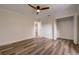 Bedroom with hardwood floors, ceiling fan, and walk-in closet at 2679 Haines Bayshore Rd, Clearwater, FL 33760
