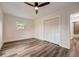 Bedroom with hardwood floors, ceiling fan, closet and updated bathroom at 2679 Haines Bayshore Rd, Clearwater, FL 33760