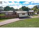 Modern home exterior with a beautiful stone accent wall, well-manicured lawn, and a stylish horizontal fence at 2679 Haines Bayshore Rd, Clearwater, FL 33760