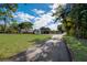 Expansive front lawn and long drive offer privacy and a grand sense of arrival at 2679 Haines Bayshore Rd, Clearwater, FL 33760