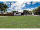 Charming single-story home with a well-manicured lawn and driveway on a large property at 2679 Haines Bayshore Rd, Clearwater, FL 33760