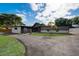Well-maintained home featuring a manicured lawn and elegant stone accents at 2679 Haines Bayshore Rd, Clearwater, FL 33760