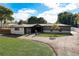 Charming single-story home featuring a well-maintained lawn, mature landscaping, and a welcoming entrance at 2679 Haines Bayshore Rd, Clearwater, FL 33760