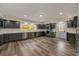 Spacious kitchen featuring gray cabinets, quartz countertops, stainless steel appliances, and tile backsplash at 2679 Haines Bayshore Rd, Clearwater, FL 33760